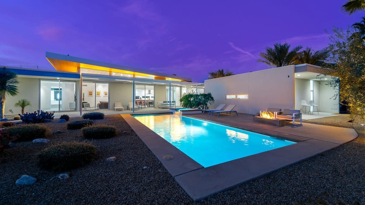 A villa exterior lit and watched over after dark